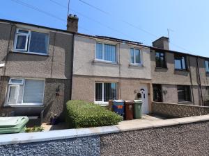 an apartment building with two trash cans in front of it at 31 Ffordd Y Maer in Pwllheli