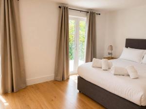 a bedroom with a large bed and a window at Watersmeet Terrace in Lynmouth