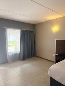 Televisor o centre d'entreteniment de The Eden Hotel Germiston
