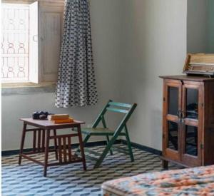 a room with a table and a chair and a desk at DanCenter Kolpol by CheckIn Udaipur in Udaipur