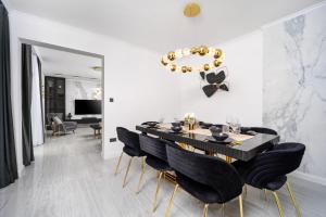a dining room with a black table and black chairs at Villa Christy in Čara