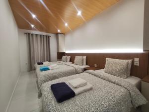 a room with three beds with towels on them at Quinta Cunha in São Pedro do Sul +59 photos