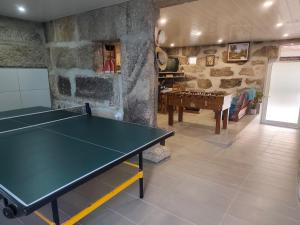 a ping pong table in a room with a ping pong ball at Quinta Cunha in São Pedro do Sul
