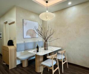 a dining room with a table with a bottle of wine at Chill House in Hai Phong