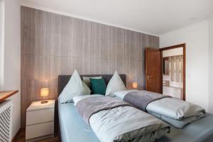 a bedroom with a bed with two pillows at Haus Tannenberg in Todtnau