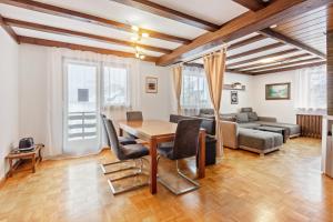 a living room with a table and chairs and a couch at Haus Tannenberg in Todtnau