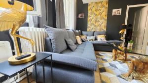 a living room with a blue couch and a table at Domaine Les Tourelles - Gîte 3 in Caffiers