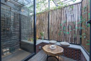 an outdoor patio with a table and a glass extension at JIDMI HOTEL in Xiamen