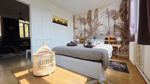 a bedroom with a bed with a bird cage at Domaine Les Tourelles - Gîte 3 in Caffiers
