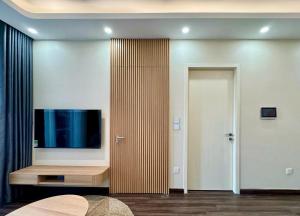 a living room with a tv on a wall at Chill House in Hai Phong