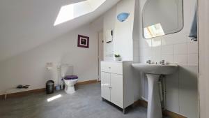 a white bathroom with a sink and a toilet at Domaine Les Tourelles - Gîte 3 in Caffiers +24 photos