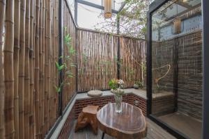 a balcony with a wooden table and a wooden fence at JIDMI HOTEL in Xiamen