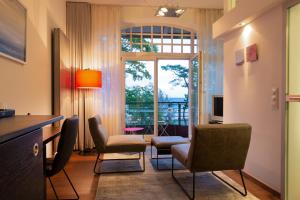 a living room with chairs and a window at niXe Boutiquehotel & Spa in Binz