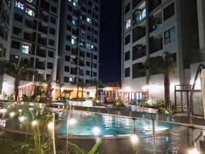 a pool in the middle of a city at night at Chill House in Hai Phong