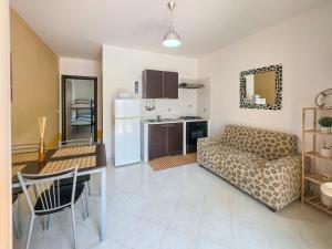 a kitchen and living room with a couch and a table at Casa Onde Chiare - Pizzo Beach Club 16G in Fondaco Vecchio