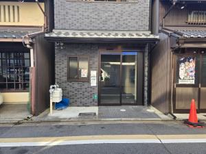 an entrance to a building with an open door at ITOSHI Kyoto Stay 京都天神401 in Kyoto