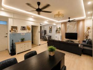 a living room with a couch and a table at Arlyn's Homestay in Sandakan