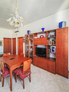 a dining room with a table and a tv at Casa Arcobaleno in Conversano