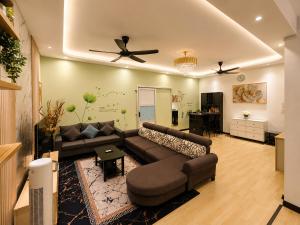 a living room with a couch and a ceiling fan at Arlyn's Homestay in Sandakan +5 photos