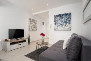 a living room with a gray couch and a tv at SILVER luxury in Pula