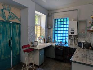 a kitchen with a sink and a stove at Номер в доме у моря с бассейном in Odesa