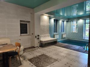 a bathroom with a swimming pool and a bath tub at Номер в доме у моря с бассейном in Odesa