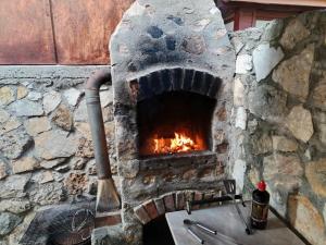 a stone oven with a fire in it at Casa Sasca Montana in Sasca Montană