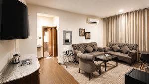 a living room with a couch and a table at Dome Al Sulaimaniah in Riyadh