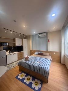a bedroom with a bed and a kitchen at Mango Home & Apartment in Danang