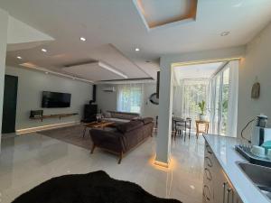 a living room with a couch and a table at Luxury villa in mountain in Geyikbayırı