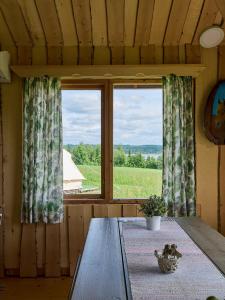 a dining room with a table and a window at Itärajan Helmi in Tohmajärvi