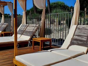 two beds on a wooden deck with a fence at ibis Styles Arcachon Gujan Mestras in Gujan-Mestras