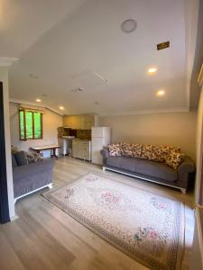 a living room with a couch and a rug at maneviga pansiyon in Çaykara