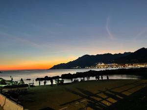 a group of people on a beach at sunset at Moonlight Drive in Cava deʼ Tirreni