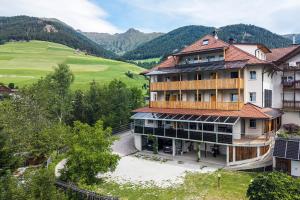 an aerial view of a building with mountains in the background at Residence Treyer in Terento