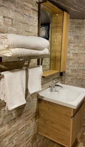 a bathroom with a sink and a mirror and towels at Dana luxury huts in Dana +157 photos