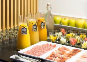 a table with a plate of food and orange juice at Hotel Elche Centro, Affiliated by Meliá in Elche +27 photos