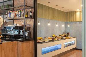 a buffet line with food on display in a restaurant at Hotel Elche Centro, Affiliated by Meliá in Elche