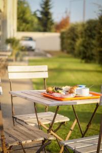 a picnic table with a plate of food on it at H24 HOTEL in Le Mans