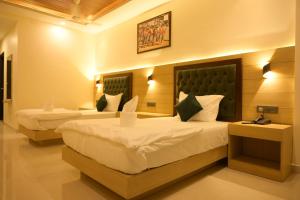 a hotel room with two beds in a room at Hotel Grand Mayfair in Dimapur +55 photos