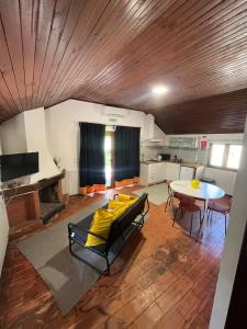 a living room with a table and a dining room at Bungalow Refúgio do Pezo T1 in Melgaço