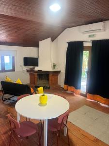 a living room with a white table and chairs at Bungalow Refúgio do Pezo T1 in Melgaço