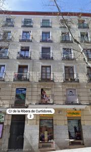 a tall building with windows and balconies on it at The Bubble in Madrid