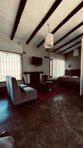 a large living room with a couch and a fireplace at Puro Campo in Tafí del Valle