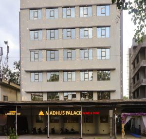 a tall building with a store in front of it at Madhu's Palace in Amarnāth