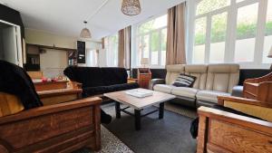a living room with a couch and a table at Domaine Les Tourelles - Gîte 2 in Caffiers
