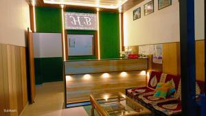 a living room with a couch and a table at Hotel Bhagirathi in Tehri-Garhwāl