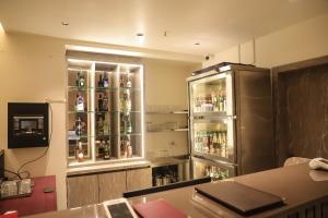 a room with a refrigerator with alcohol bottles in it at Madhu's Palace in Amarnāth