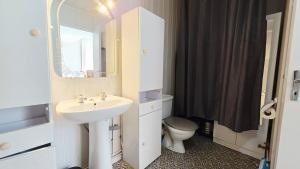 a bathroom with a sink and a toilet and a mirror at Domaine Les Tourelles - Gîte 2 in Caffiers +29 photos