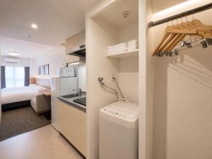 a bathroom with a washer and dryer in a room at Hotel Arashi Nippombashi 1 No006 in Osaka